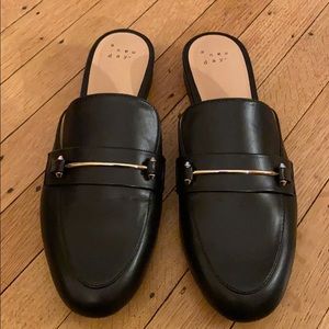 Black loafers with gold details